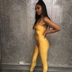 Marigold colored jumpsuit with silver rhinestones